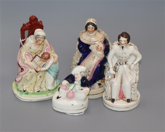 A Staffordshire figure of Queen Victoria, seated with baby and three other figures,